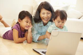 Grandmother And Grandchildren Using Laptop Together
