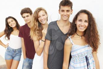 Portrait Of Teenage Group Leaning Against Wall
