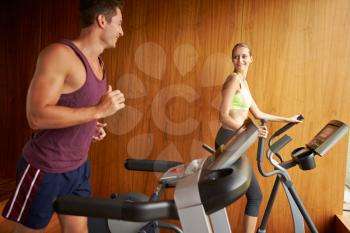Couple Exercising Together In Home Gym