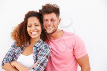Portrait Of Couple Standing Outdoors Against White Wall