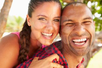 Head And Shoulders Portrait Of Loving Couple Outdoors