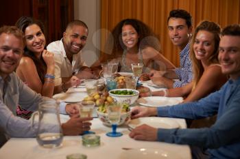 Group Of Friends Enjoying Dinner Party At Home Together