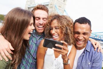 Group Of Friends Taking Selfie By Tower Bridge In London