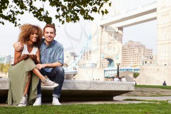 Couple Using Digital Tablet With Tower Bridge In Background