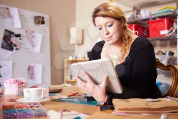 Jeweler Checking Orders For Business With Digital Tablet