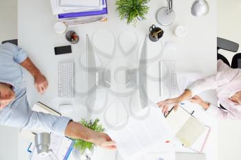 Overhead View Of Businesspeople Working At Office Computer