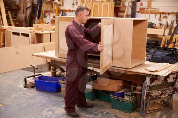 Carpenter Building Furniture In Workshop
