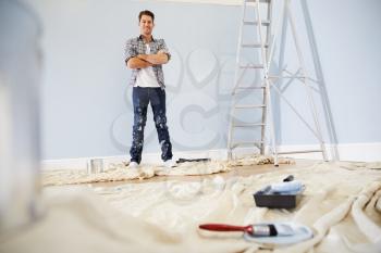 Portrait Of Man Decorating Nursery For New Baby