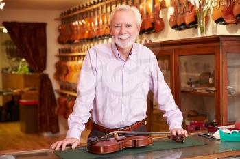 Portrait Of Violin Maker In Shop
