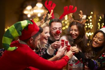 Group Of Friends Enjoying Christmas Drinks In Bar