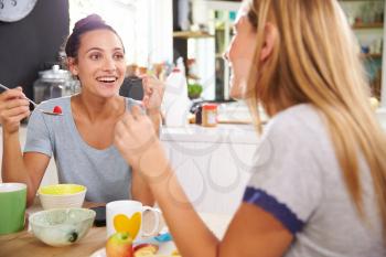 Two Female Friends Enjoying Breakfast At Home Together