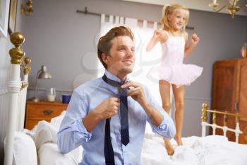 Father Dresses For Work As Daughter Plays In Bedroom