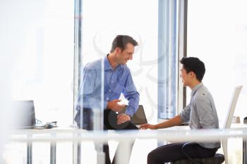 Two men talking in a modern office