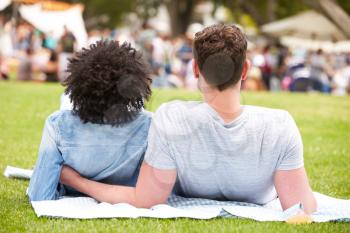 Rear View Of Couple Relaxing At Outdoor Summer Event