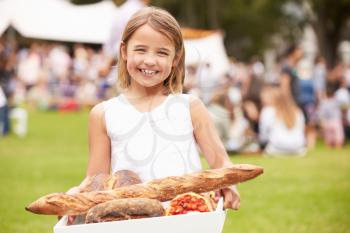 Young Girl With Fresh Bread Bought At Outdoor Farmers Market