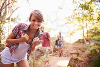 Woman On Walk With Friends Making Funny Gesture At Camera