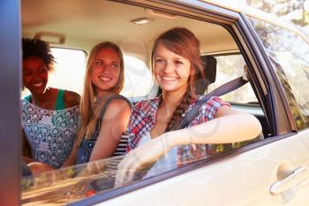Three Women Sitting In Rear Seat Of Car On Road Trip