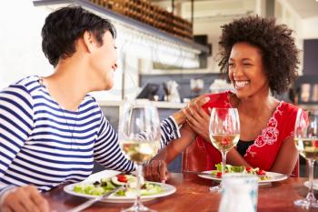 Two female friends eating at a restaurant