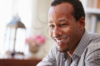Portrait ofa smiling young man sitting in a room