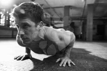 Black And White Shot Of Bare Chested Man Doing Press-Ups