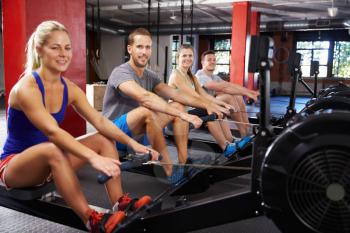 Portrait Of Gym Class Working Out On Rowing Machines