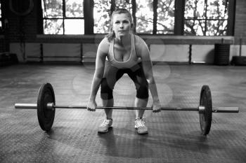 Black And White Shot Of Woman Preparing To Lift Weights