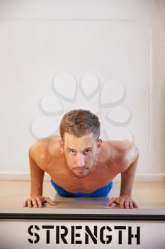 Bare Chested Man In Gym Doing Press-Ups