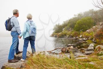 Senior couple standing by a lake