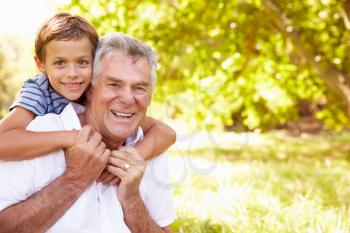 Grandfather having fun outdoors with his grandson, portrait