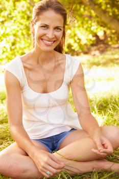 Young woman sitting on grass relaxing