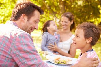 Family eating together outdoors
