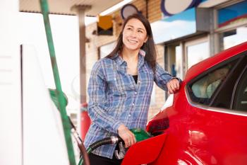 Woman man refuelling a car at a petrol station