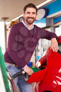 Man refuelling a car at a petrol station