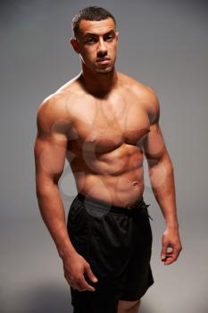 Male bodybuilder looking at the camera, standing portrait