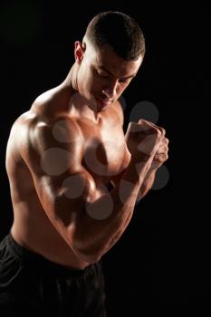 Male bodybuilder flexing muscles