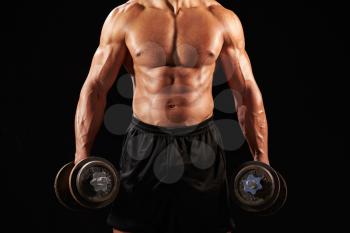 Male bodybuilder working out with heavy dumbbell, crop