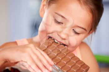 Close Up Of Girl Eating Bar Of Chocolate