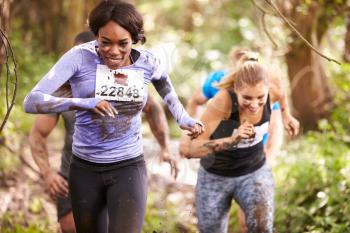 Two women enjoying a run in a forest at an endurance event