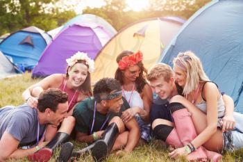 Friends having fun on the campsite at a music festival