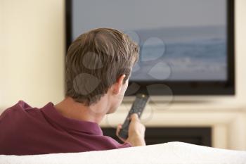 Man Watching Widescreen TV At Home
