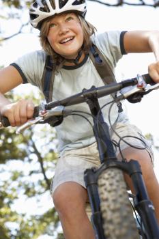 Teenage Boy Cycling Through Countryside