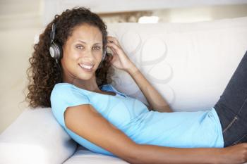 Young Woman Relaxing Listening To Music At Home