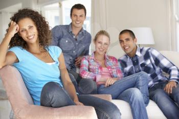 Group Of Friends Relaxing On Sofa At Home Together
