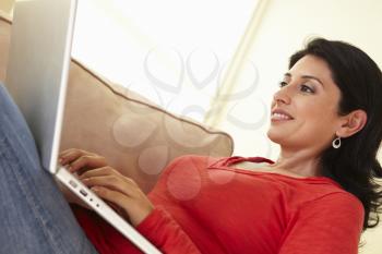Hispanic Woman Using Laptop At Home