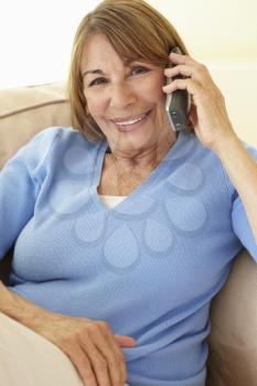 Senior Hispanic Woman Using Cellphone At Home