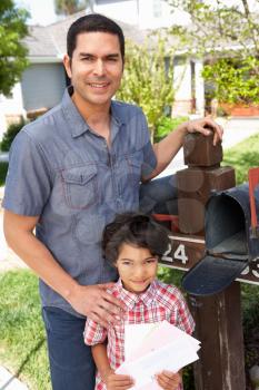 Hispanic Father And Son Checking Mailbox