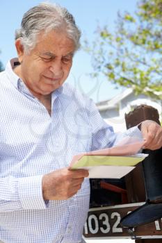 Worried Senior Hispanic Man Checking Mailbox