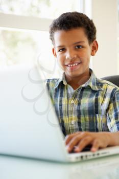 Boy Using Laptop At Home