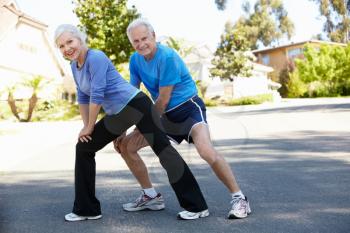 Elderly man and younger woman jogging