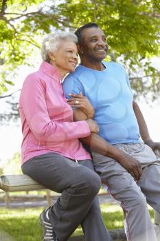 Portrait Of Senior African American Couple Wearing Running Clothing In Park